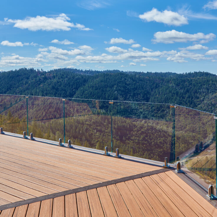 Photo of glass railing on deck overlooking mountains