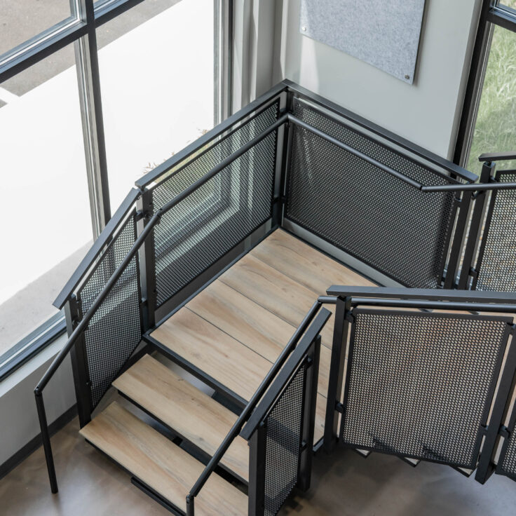 Floating Stairs with Porcelain Treads and Perforated Railing Panels